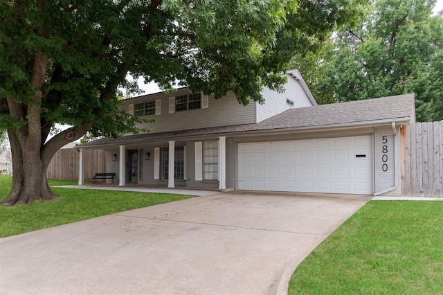 view of front of home with a porch, a garage, and a front lawn