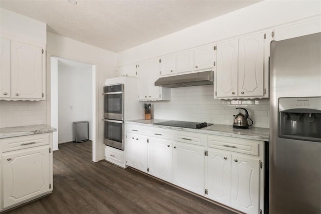 kitchen featuring white cabinets, tasteful backsplash, stainless steel appliances, and dark wood-type flooring