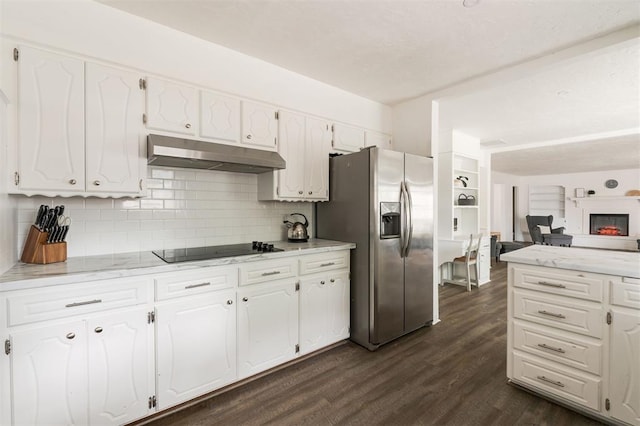 kitchen featuring white cabinets, stainless steel fridge, dark hardwood / wood-style flooring, and black electric cooktop