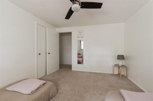 carpeted bedroom featuring a closet and ceiling fan