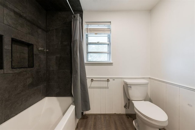 bathroom featuring hardwood / wood-style flooring, shower / bath combo, and toilet