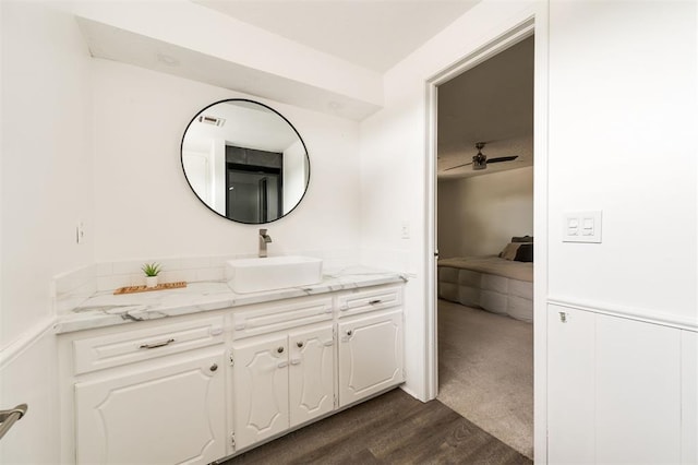 bathroom with ceiling fan, vanity, and wood-type flooring