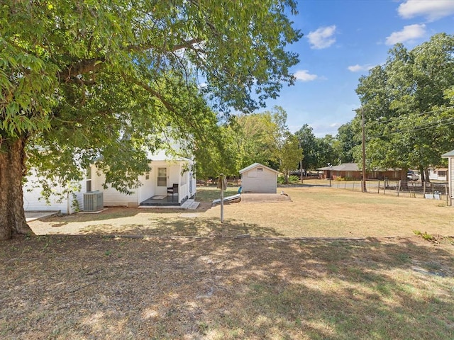 view of yard featuring central AC and an outbuilding