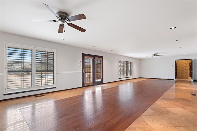 spare room with light tile patterned flooring and ceiling fan