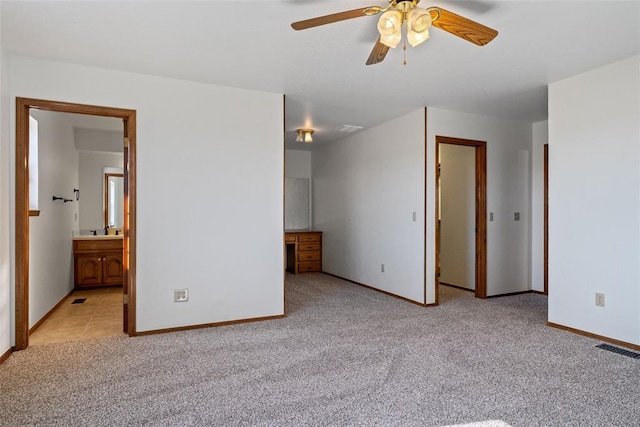 unfurnished bedroom with light colored carpet and ensuite bath