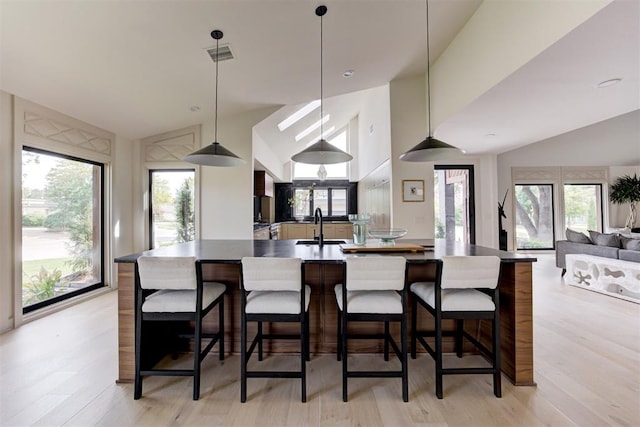 kitchen featuring light wood-style floors, visible vents, and a wealth of natural light