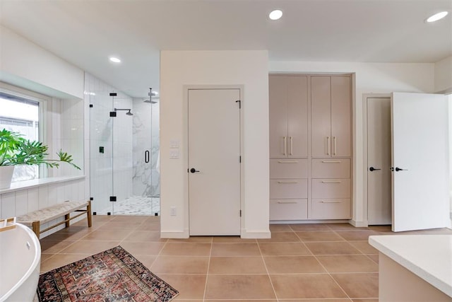 full bathroom with tile patterned flooring, recessed lighting, a stall shower, and a freestanding tub