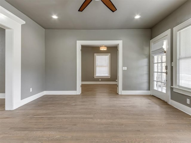 unfurnished room featuring ceiling fan and light hardwood / wood-style flooring