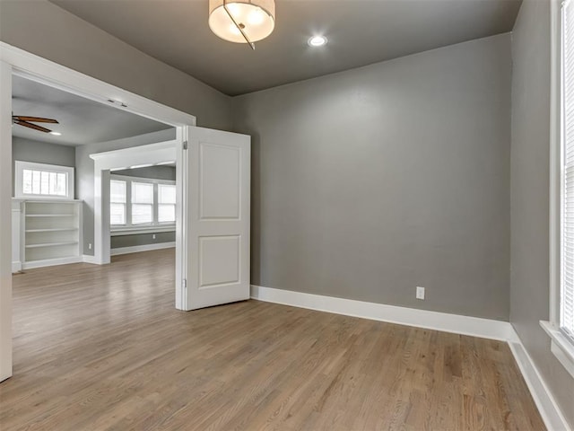 empty room featuring ceiling fan and light hardwood / wood-style flooring