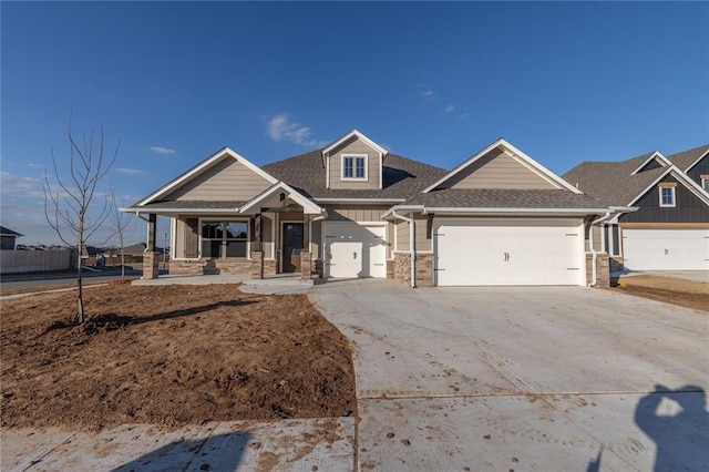 craftsman inspired home featuring a garage and a porch