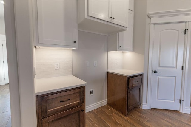 kitchen featuring white cabinets, tasteful backsplash, and dark brown cabinetry