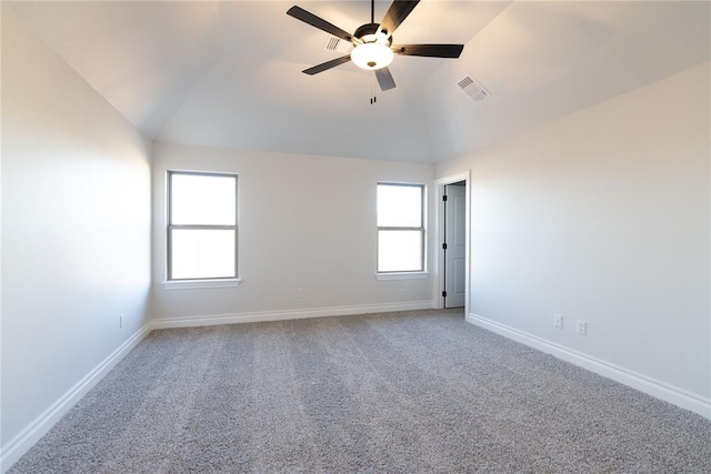 carpeted empty room with ceiling fan and vaulted ceiling