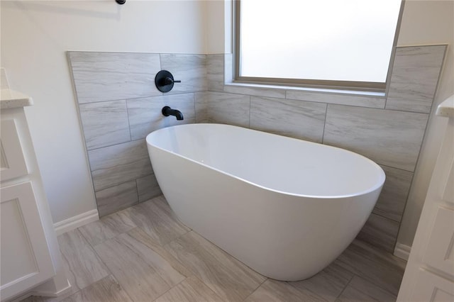 bathroom featuring a tub and vanity