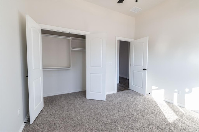 unfurnished bedroom with ceiling fan, a closet, and carpet flooring