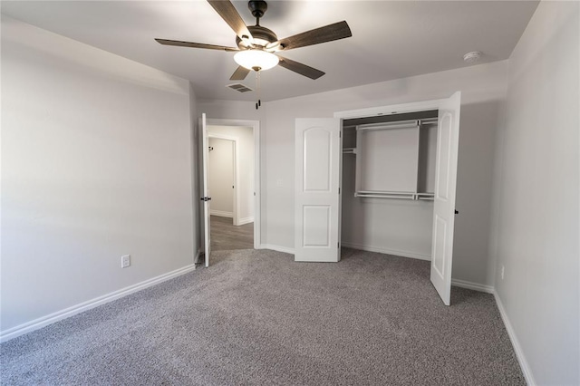 unfurnished bedroom featuring ceiling fan, a closet, and carpet