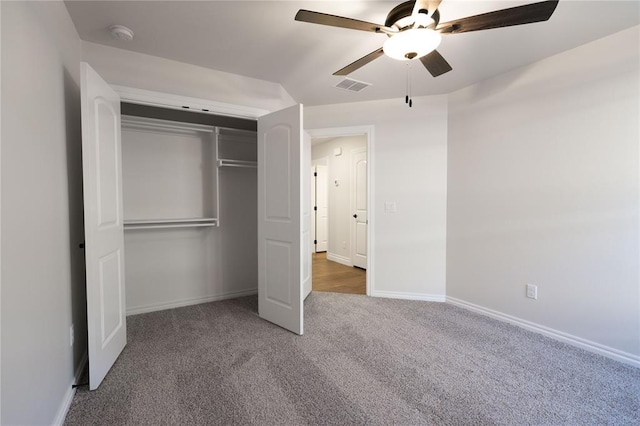 unfurnished bedroom featuring carpet flooring, a closet, and ceiling fan