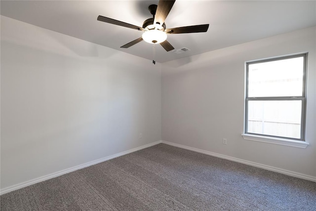 spare room with carpet floors and ceiling fan