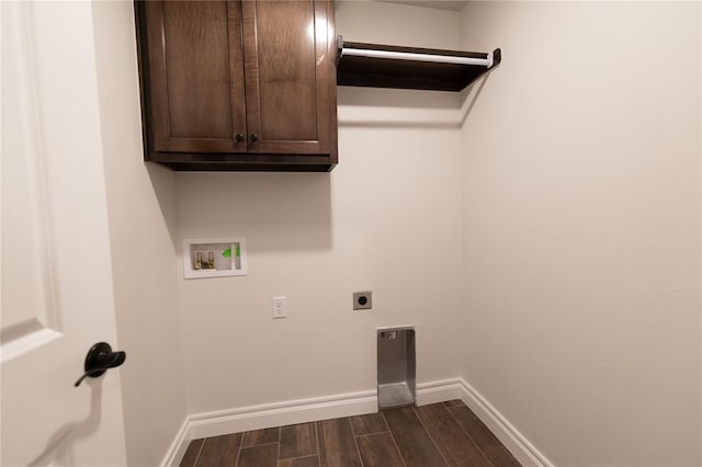 clothes washing area with hookup for a washing machine, cabinets, and hookup for an electric dryer