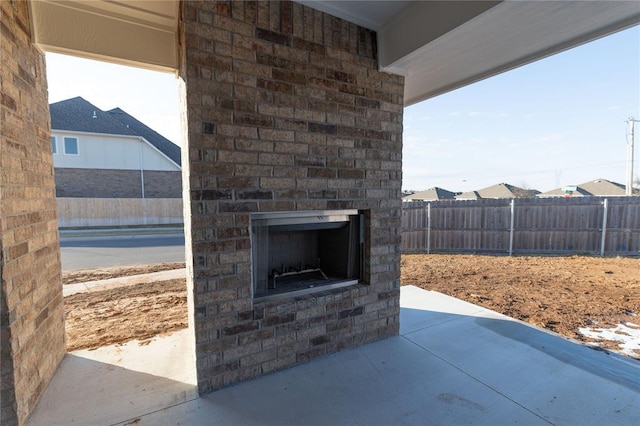 view of patio with an outdoor brick fireplace