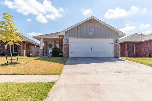 view of front of home featuring a garage and a front lawn