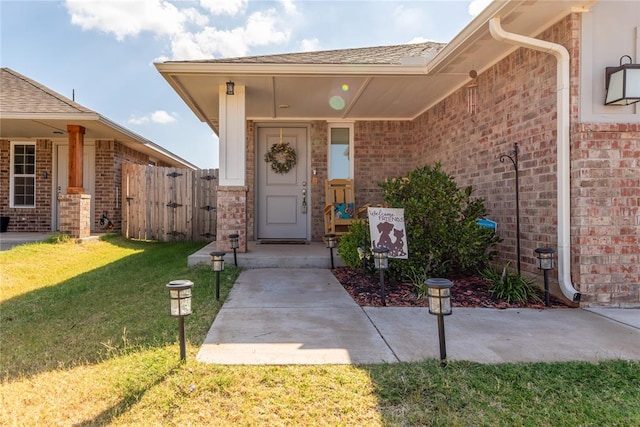 doorway to property featuring a lawn and a patio