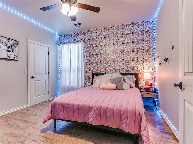 bedroom with ceiling fan and light hardwood / wood-style flooring