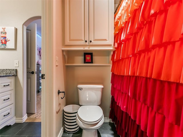 bathroom with tile patterned flooring, vanity, and toilet