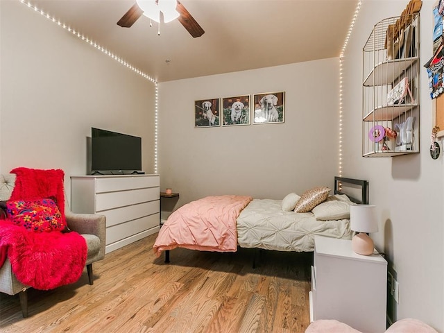 bedroom with ceiling fan and wood-type flooring