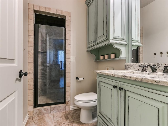 bathroom with an enclosed shower, vanity, and toilet