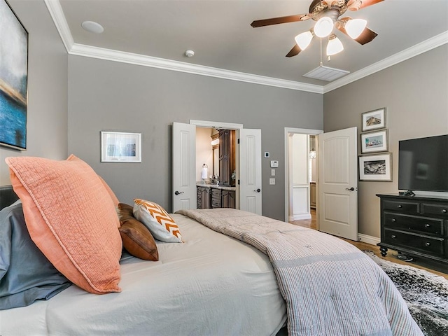 bedroom featuring ceiling fan, wood-type flooring, ornamental molding, and ensuite bath