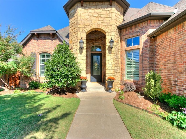 doorway to property with a yard