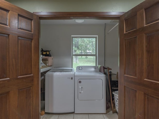 washroom with light tile patterned flooring and separate washer and dryer