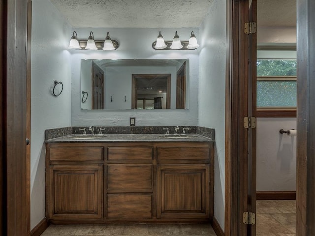 bathroom with vanity and a textured ceiling