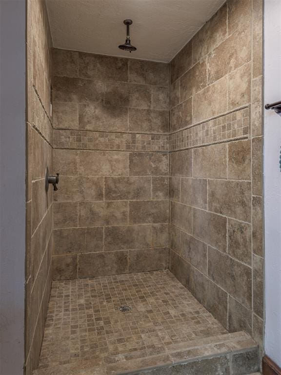 bathroom with a tile shower