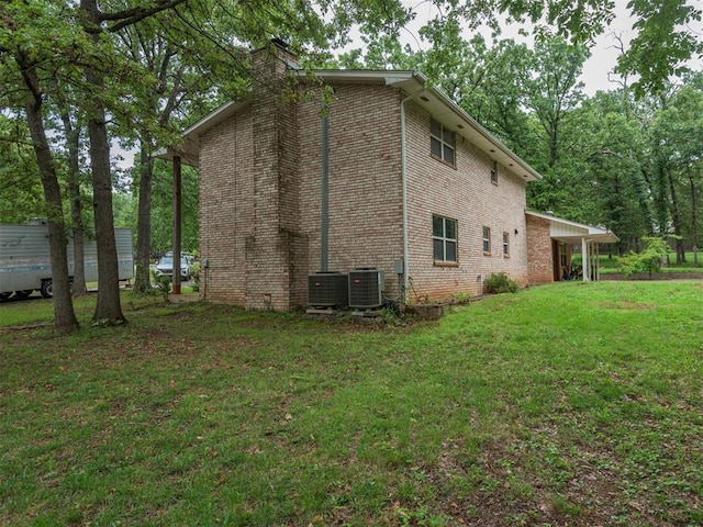 view of property exterior with central AC and a lawn