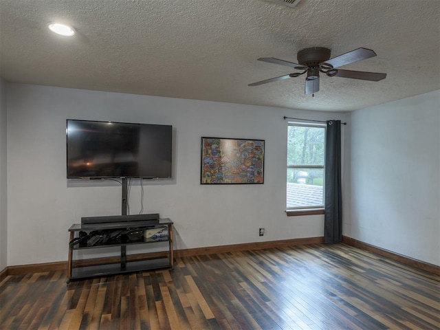 living room with dark hardwood / wood-style flooring, ceiling fan, and a textured ceiling