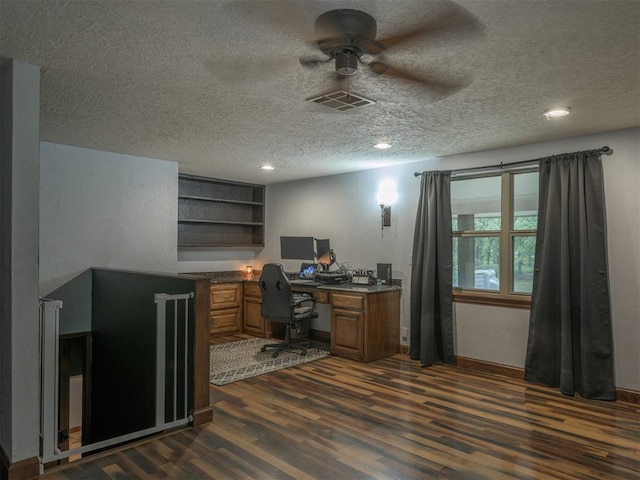 home office featuring dark wood-type flooring, ceiling fan, and a textured ceiling