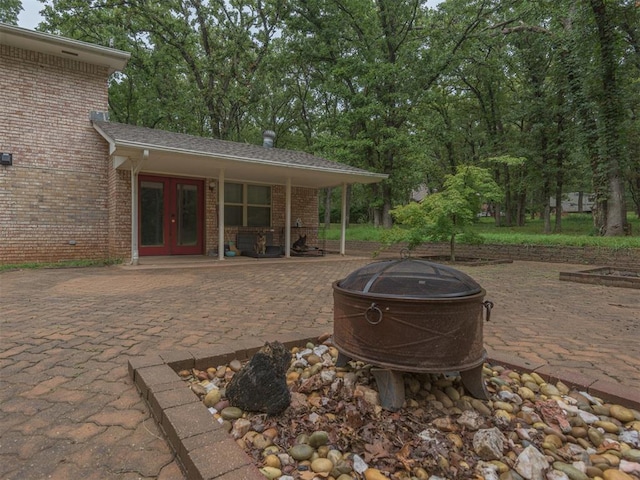 view of patio / terrace with french doors and an outdoor fire pit