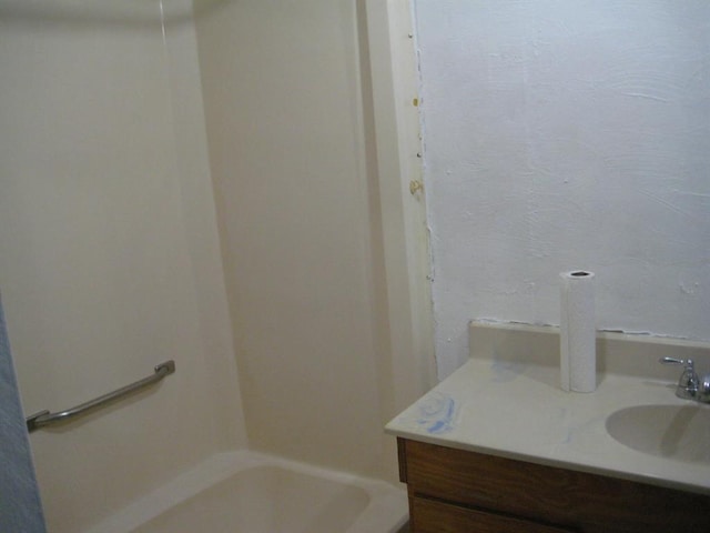 bathroom with vanity and a tub