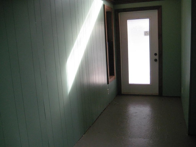 spare room featuring wooden walls