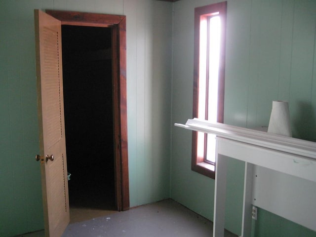 unfurnished bedroom with wood walls