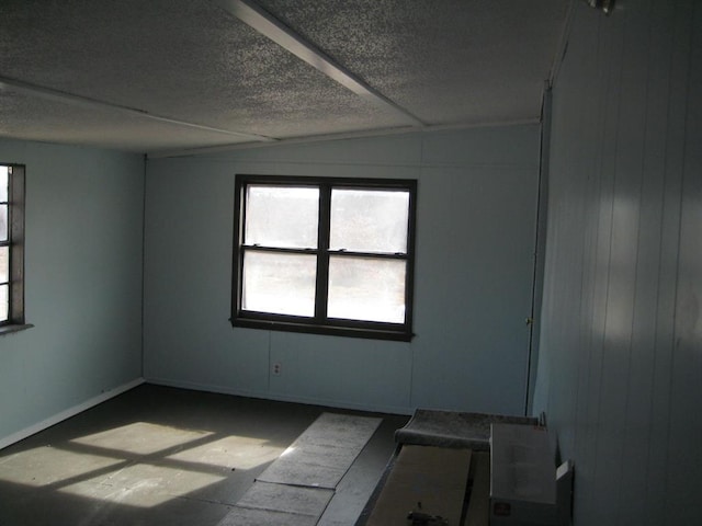 unfurnished room featuring a textured ceiling