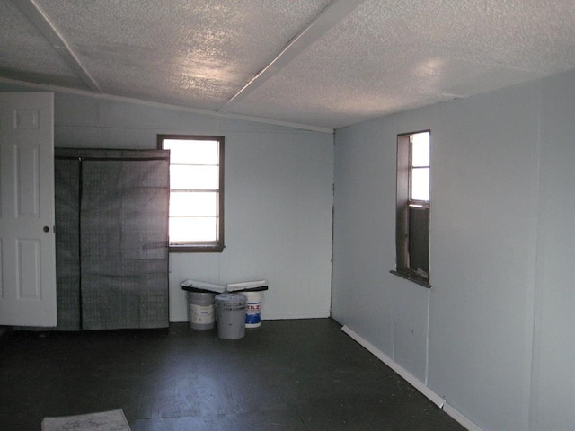 unfurnished room featuring plenty of natural light and a textured ceiling