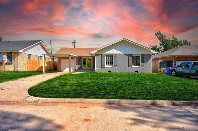 view of front of house featuring french doors, a yard, and a garage