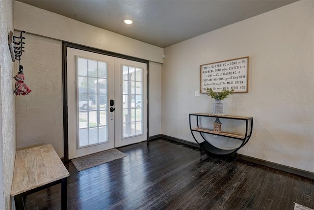 entryway featuring dark wood-type flooring and french doors