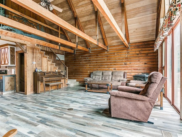 unfurnished living room featuring high vaulted ceiling, hardwood / wood-style flooring, ceiling fan, beamed ceiling, and wood ceiling