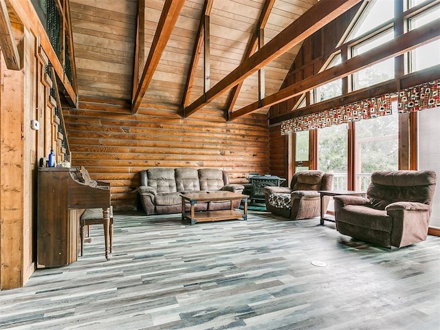 unfurnished living room featuring hardwood / wood-style floors, beam ceiling, wooden ceiling, and high vaulted ceiling