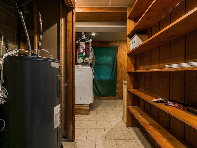 interior space featuring electric water heater and washer / dryer