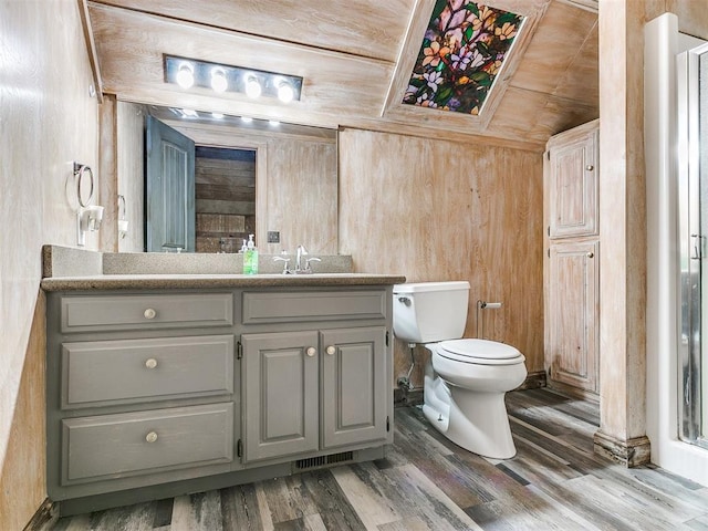 bathroom with hardwood / wood-style flooring, vanity, wood ceiling, and wooden walls