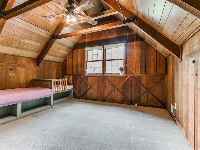 unfurnished bedroom featuring carpet flooring, wood ceiling, and wooden walls